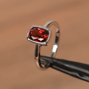 Cushion cut red garnet promise ring on silver