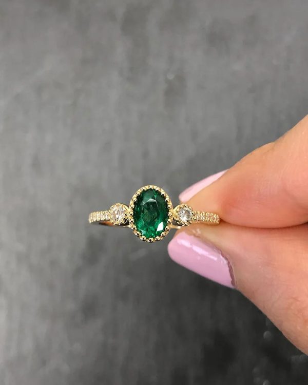 Oval Tsavorite 0.80cts ring set on 18 karat yellow gold with cubic zirconia