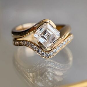 2.5ct ascher cut moissanite set on 18k gold band with a wedding band