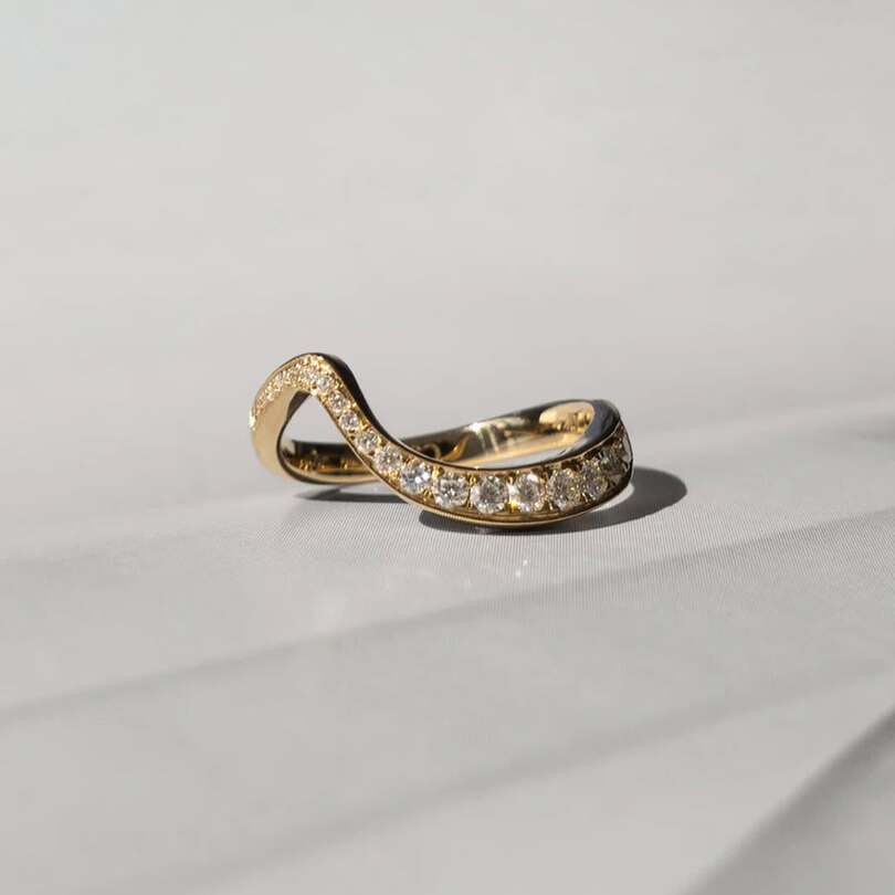 Ocean pave band with ascending moissanites on 18 karat gold