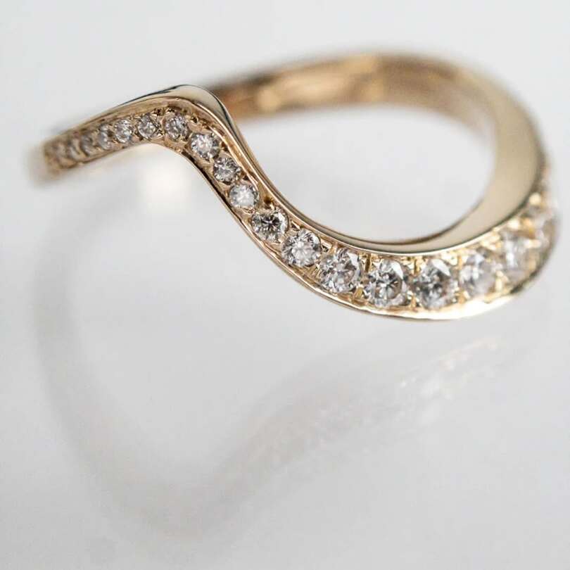 Ocean pave band with ascending moissanites on 18 karat gold