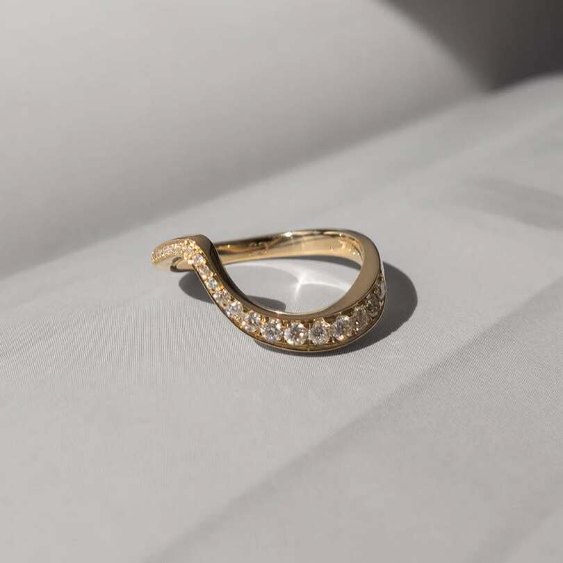 Ocean pave band with ascending moissanites on 18 karat gold