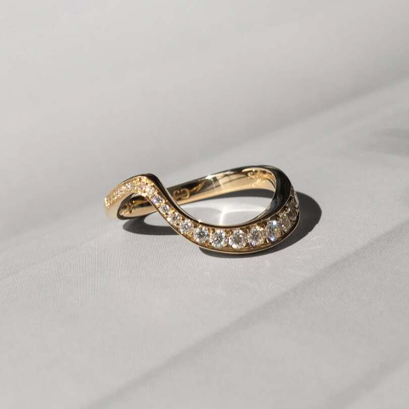 Ocean pave band with ascending moissanites on 18 karat gold